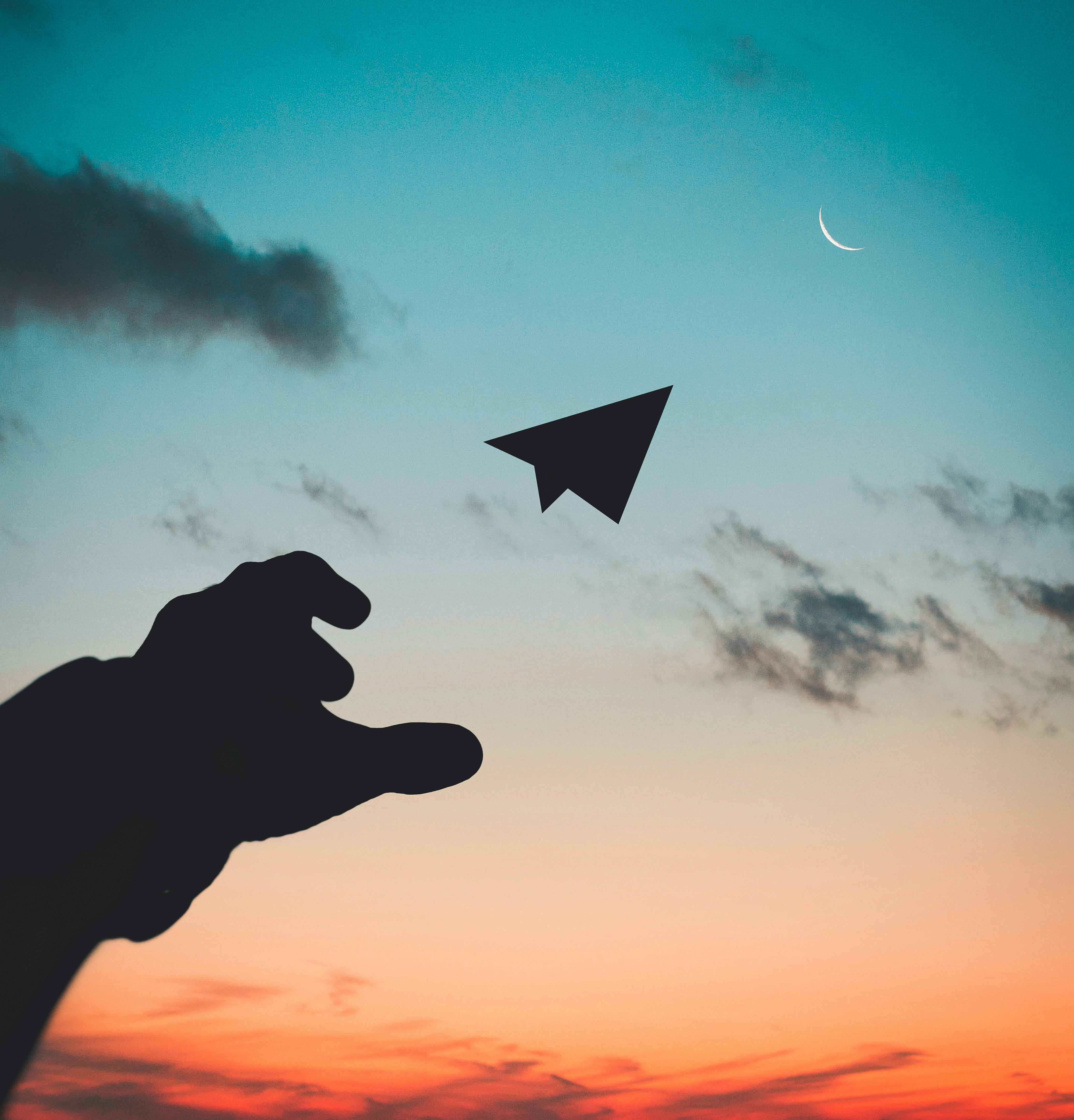 Paper airplane at sunset